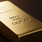 Stacks of gold bars with rising price chart in background