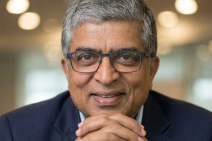 Nandan Nilekani standing in front of a digital projection showcasing futuristic examination security technology and the NTA logo.