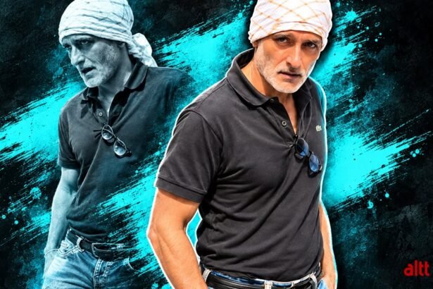 Akshaye Khanna seen in a rare public appearance wearing a white head wrap, black T-shirt and blue jeans.